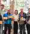 People holding their B Corp wooden plaque proudly.
