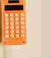 an orange calculator on a notebook